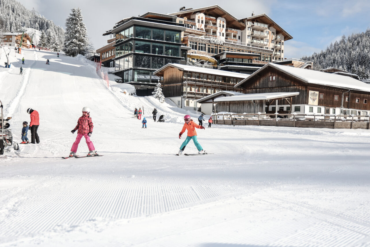 Skifahrende Kinder im verschneiten Skigebiet